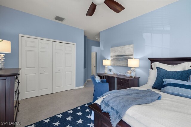 carpeted bedroom with ceiling fan and a closet