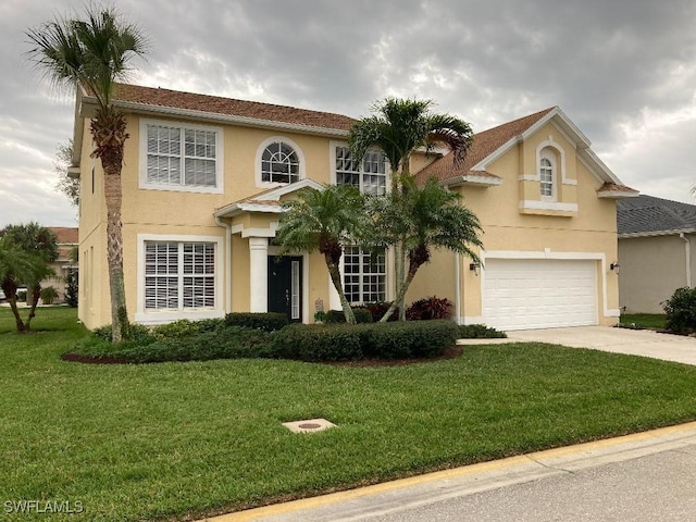 view of front facade with a garage and a front lawn