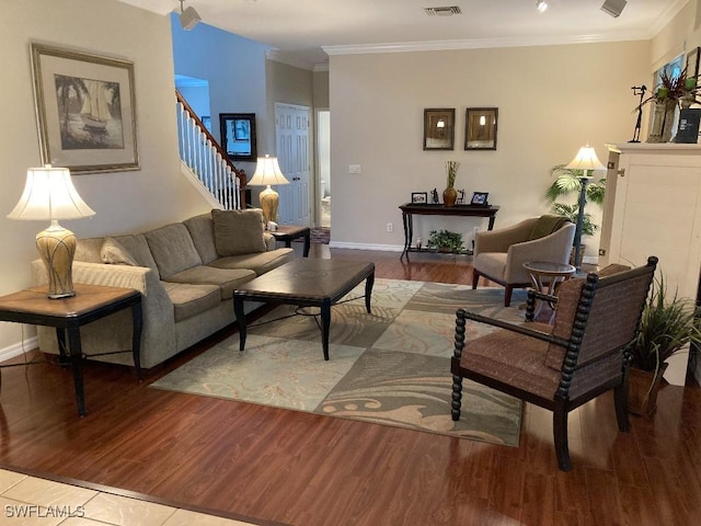 living room with crown molding and light wood-type flooring