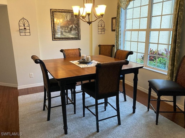 dining area featuring a notable chandelier and hardwood / wood-style flooring