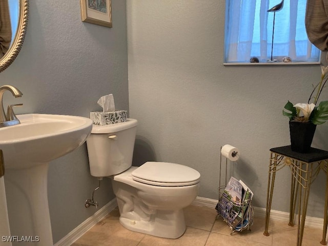 bathroom featuring tile patterned floors, toilet, and sink