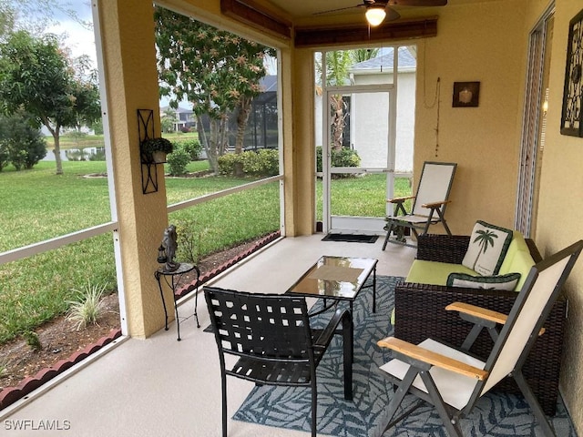 sunroom featuring ceiling fan