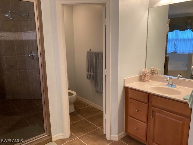 bathroom featuring vanity, a shower with shower door, tile patterned floors, and toilet