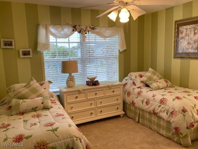 carpeted bedroom with ceiling fan and multiple windows