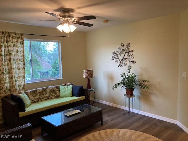 living room featuring ceiling fan and dark hardwood / wood-style floors