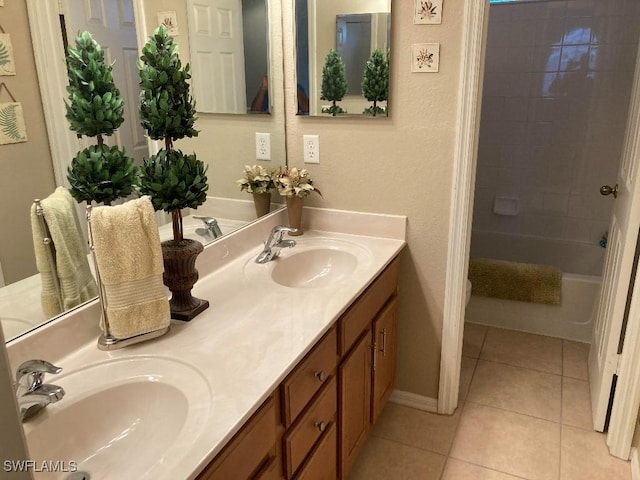 bathroom featuring tiled shower / bath, tile patterned floors, and vanity