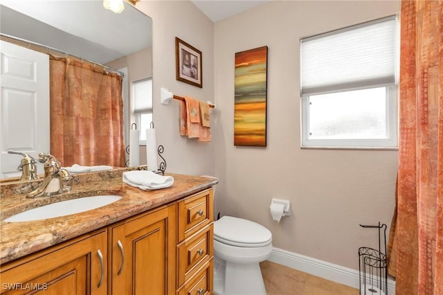 bathroom featuring vanity, toilet, and tile patterned flooring