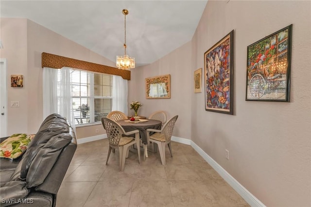 tiled dining space with a chandelier and vaulted ceiling