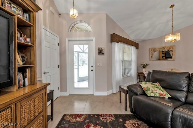 entrance foyer with lofted ceiling and light tile patterned floors