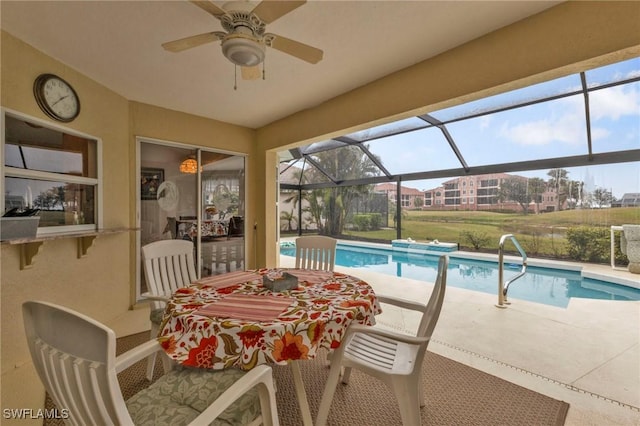 view of swimming pool featuring a lanai, a patio area, and ceiling fan