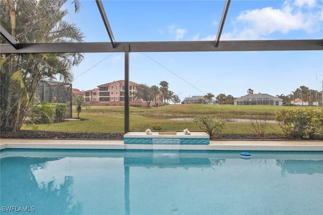 view of pool featuring a lanai and a lawn