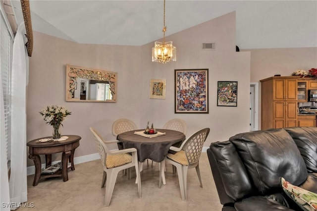 dining room featuring vaulted ceiling and a chandelier