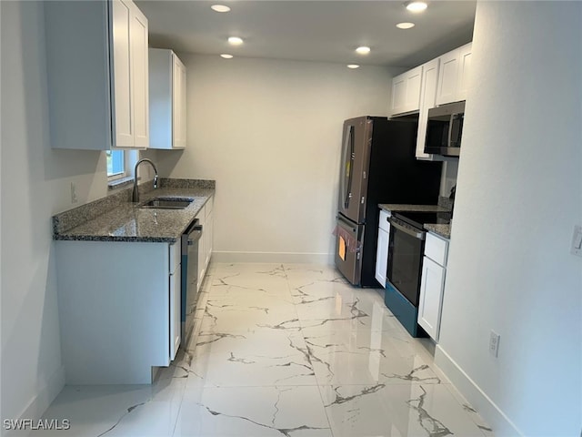 kitchen with stainless steel appliances, sink, white cabinets, and dark stone counters