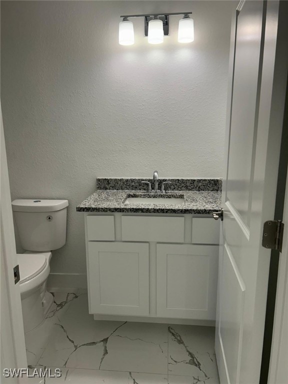 bathroom with vanity and toilet