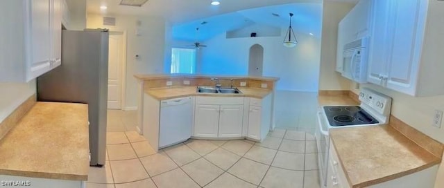 kitchen with sink, white appliances, light tile patterned floors, white cabinets, and decorative light fixtures