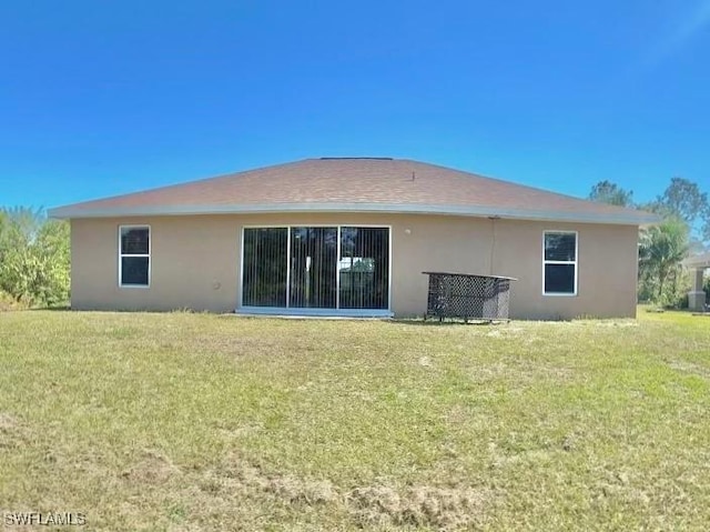 back of house with a lawn