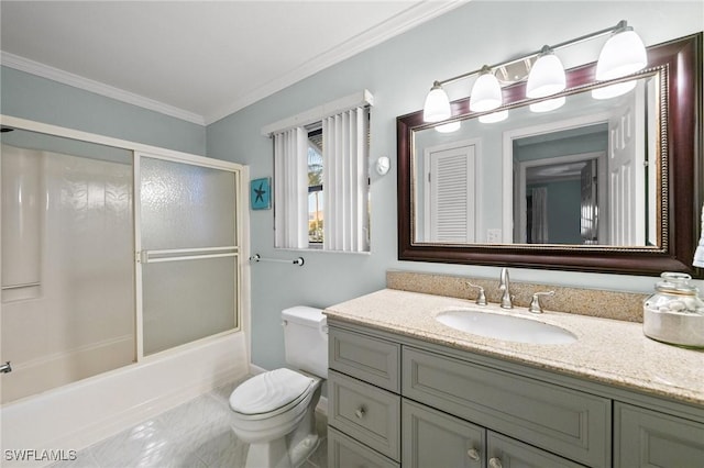 full bathroom featuring crown molding, shower / bath combination with glass door, vanity, tile patterned floors, and toilet