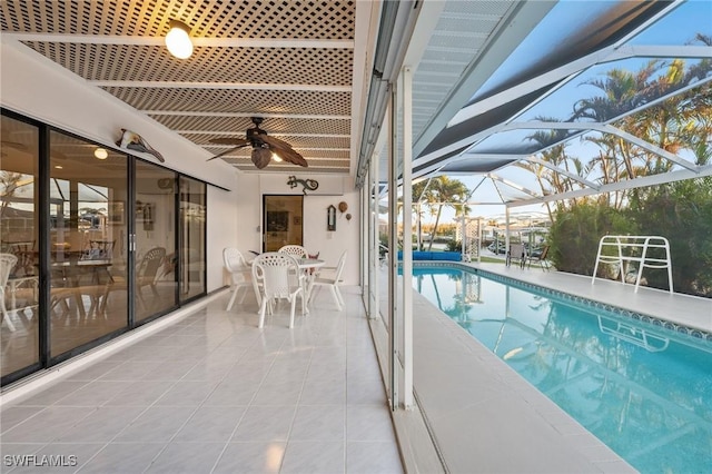 view of pool featuring ceiling fan, a lanai, and a patio