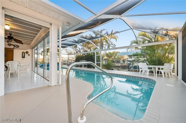 view of swimming pool with a lanai and a patio