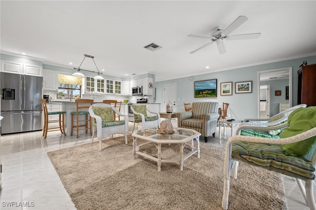 living room featuring ceiling fan and ornamental molding