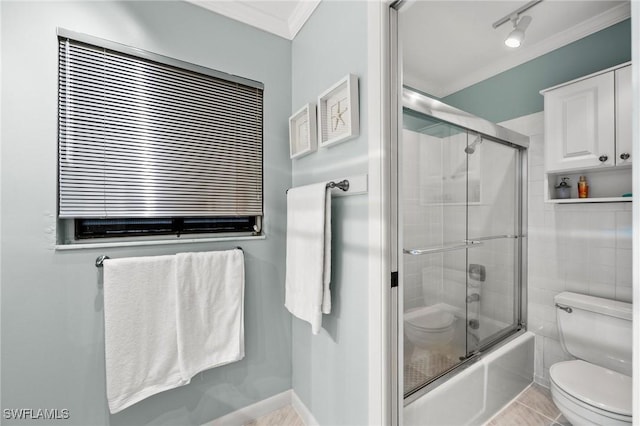 bathroom with crown molding, enclosed tub / shower combo, tile patterned floors, and toilet