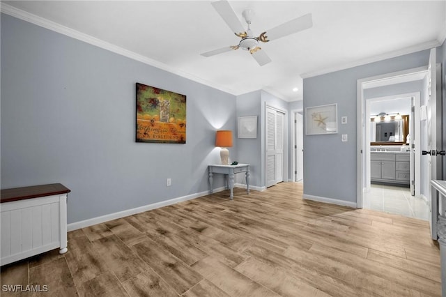 interior space with ceiling fan, ornamental molding, and light wood-type flooring