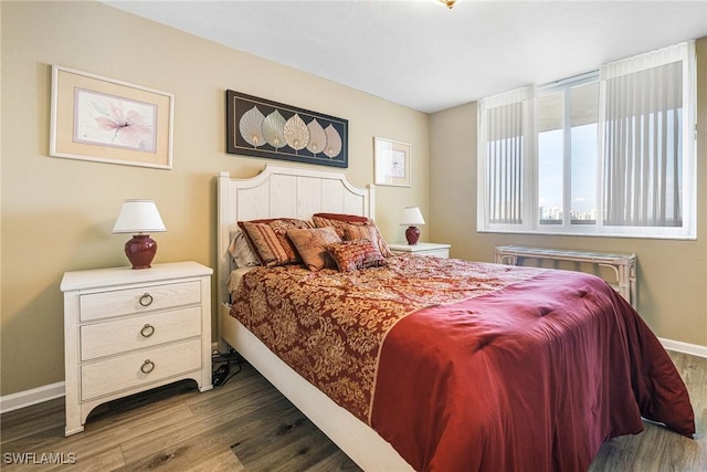 bedroom with dark hardwood / wood-style floors