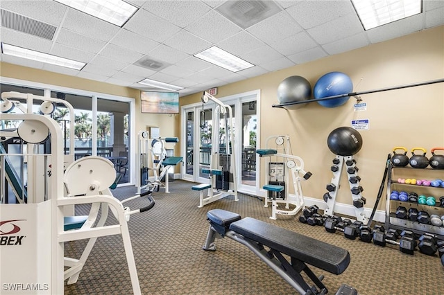 workout area featuring a drop ceiling and french doors