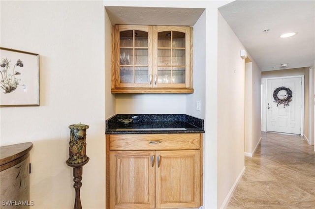 bar featuring dark stone countertops