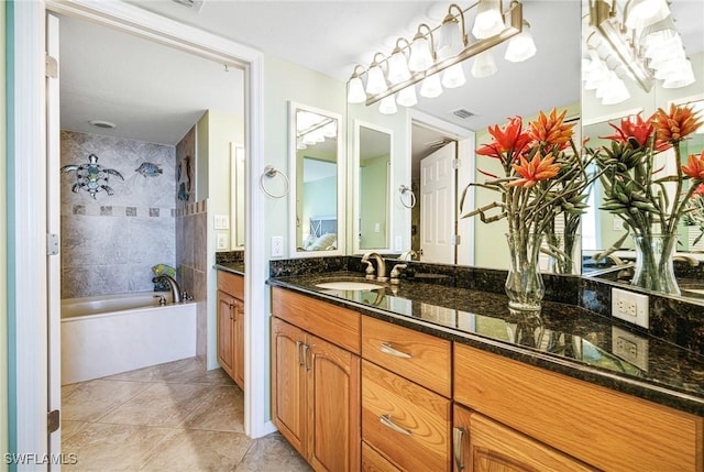 bathroom with vanity, a bath, and tile patterned flooring