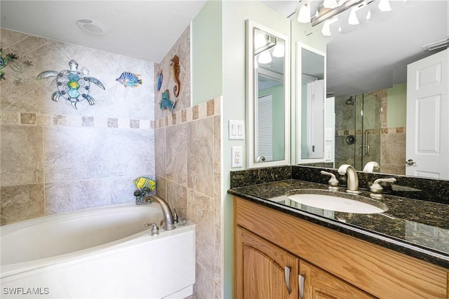 bathroom featuring plus walk in shower and vanity