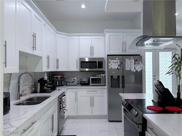 kitchen featuring island exhaust hood, appliances with stainless steel finishes, sink, and white cabinets