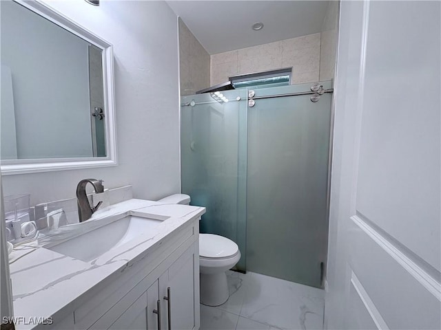 bathroom with vanity, toilet, and walk in shower