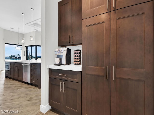 kitchen with wall oven, hanging light fixtures, dishwasher, and light wood-type flooring