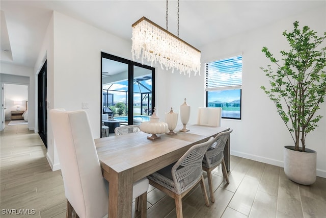 dining room with an inviting chandelier and light wood-type flooring