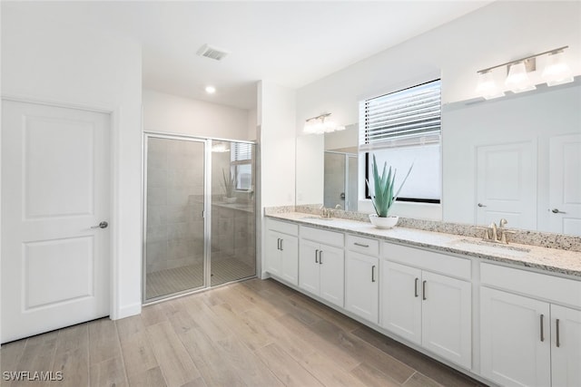 bathroom featuring vanity and an enclosed shower