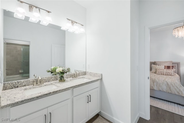 bathroom with vanity and an inviting chandelier