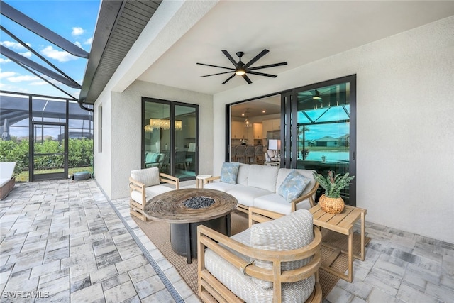 view of patio with an outdoor living space, a lanai, and ceiling fan