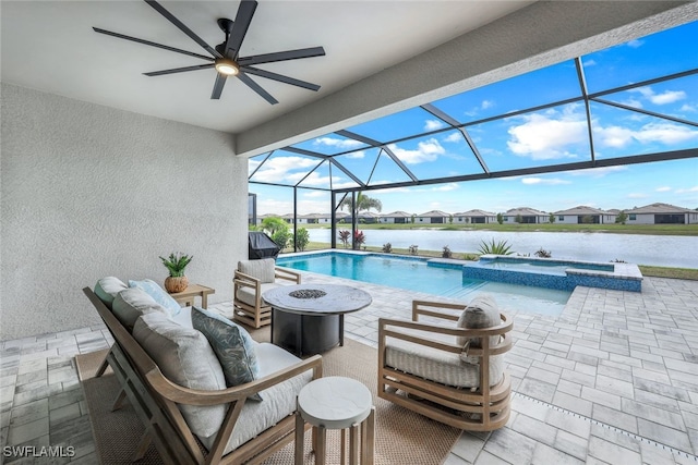 view of pool featuring a patio area, an outdoor living space with a fire pit, glass enclosure, and an in ground hot tub