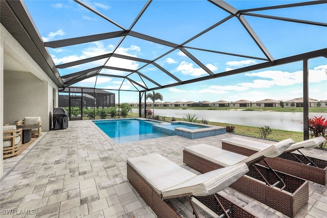 view of swimming pool with an in ground hot tub, a water view, a patio, and glass enclosure