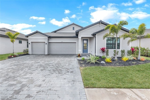 ranch-style house featuring a garage and a front lawn