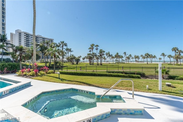 view of pool with a yard and a community hot tub