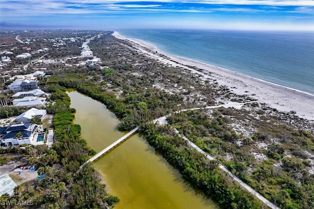 bird's eye view with a water view and a beach view