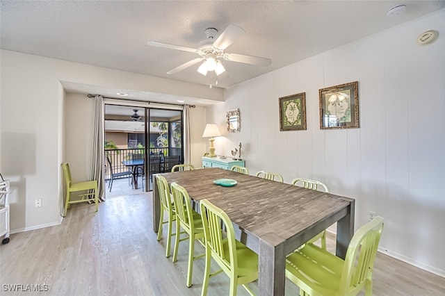 dining area featuring ceiling fan, light hardwood / wood-style floors, and a textured ceiling