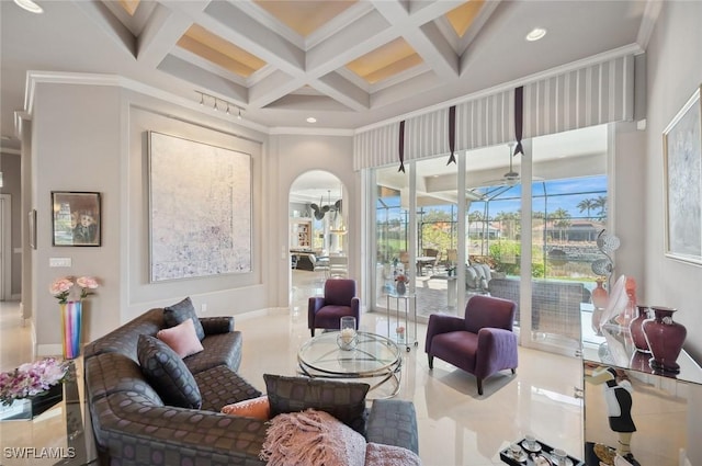 interior space with crown molding, a towering ceiling, coffered ceiling, and beam ceiling