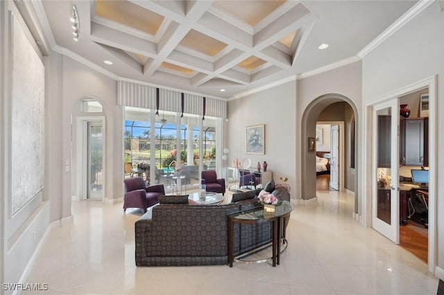 living room featuring beamed ceiling, ornamental molding, coffered ceiling, and a high ceiling