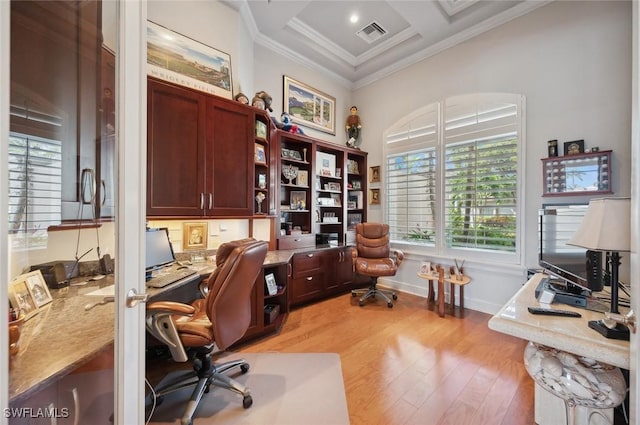 office featuring built in desk, light wood-type flooring, ornamental molding, coffered ceiling, and beam ceiling