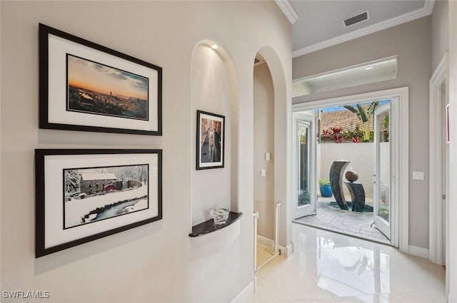 interior space featuring light tile patterned flooring and ornamental molding