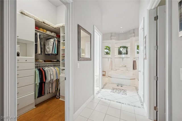 interior space with a relaxing tiled tub and tile patterned floors