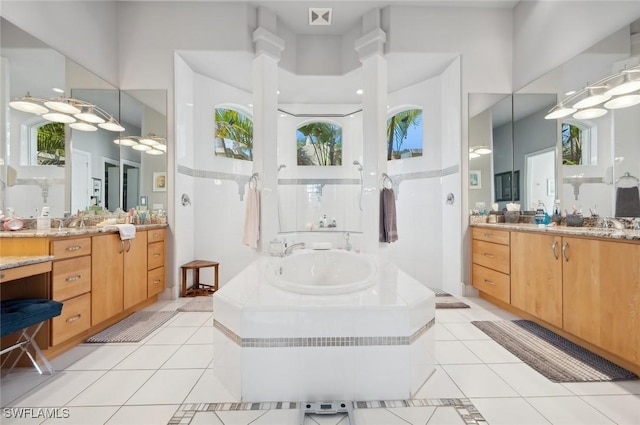 bathroom featuring vanity, tile patterned floors, and walk in shower